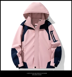 Detail of waterproof pink and navy outdoor jacket with hood and functional arm pocket