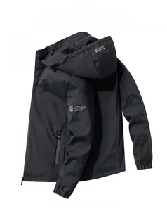 Detail of black hooded jacket featuring windproof fabric and white decorative text prints