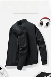 Detailed flat lay of black street style bomber jacket with ribbed cuffs and sleeve print