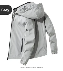 Detail of light grey windbreaker jacket featuring zipper pockets and adjustable drawstring hood