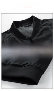 Detail of bomber collar and ribbed hem on a black casual jacket with high-density windproof fabric