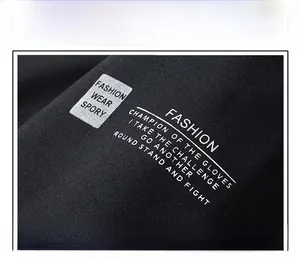 Detail view of fashion letter printing on the sleeve of a black hooded jacket for men