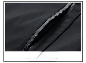 Detail view of matte black windproof jacket featuring a secure nylon zipper side pocket