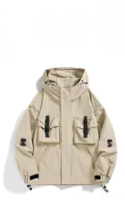 Detail of khaki outdoor hooded jacket featuring oversized cargo pockets and drawcord hem