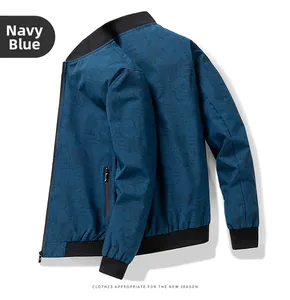 Detail of navy blue bomber jacket with leaf print, ribbed cuffs, and zipper pocket
