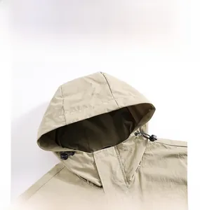 Detailed close-up of khaki outdoor hooded jacket with windproof collar and fine fabric texture