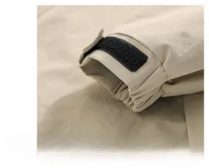 Close-up of adjustable velcro cuff and windproof fabric on khaki outdoor jacket