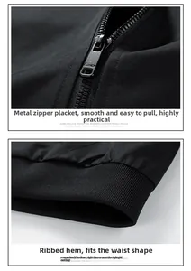 Close-up of matte metal zipper and high-density ribbed hem on black windproof jacket