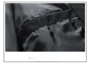 Detail shot of the secure inner pocket and fine polyester lining of the black jacket