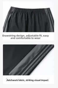 Detail der elastischen Taille mit Kordelzug und Seitenstreifen an schwarzer Sporthose