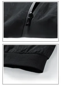 Detail of metal zipper with waterproof tape and ribbed hem on black patterned jacket