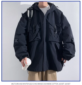 Detailed view of black tactical hooded jacket with multi-pocket design and utility buckles