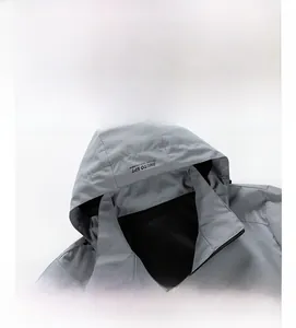 Detail of light gray hooded jacket showing zipper and breathable black mesh lining
