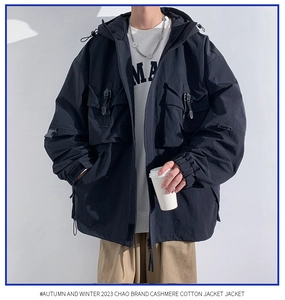 Macro detail of hooded cargo jacket featuring multiple utility pockets and tactical straps