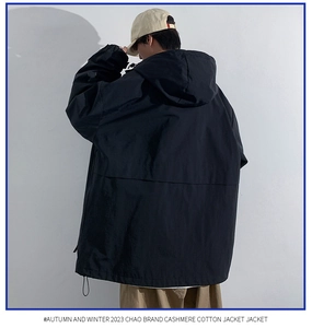 Rear view of black hooded jacket with drawstring hem and relaxed streetwear fit