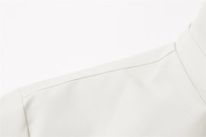 Dettaglio delle cuciture sulle spalle e del colletto di una giacca casual beige