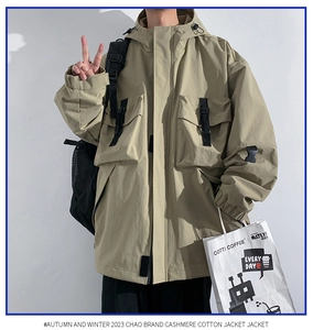 Detail of khaki hooded utility jacket featuring functional cargo pockets and buckle straps