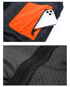 Dettaglio giacca softshell con tasca arancione con cerniera per lo smartphone
