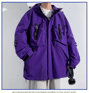 Detail of dark purple hooded cargo jacket with large chest pockets and buckle closure