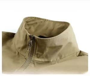 Detail view of khaki fishing vest showing standing collar and durable metal zipper