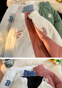 Detailed view of winter fleece jacket showing vintage embroidery and corduroy collar texture