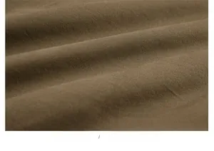 Macro detail of brown washed cotton fabric texture on a warm bomber jacket