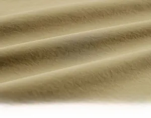 Macro detail of breathable khaki fabric with uniform texture and natural weaving patterns