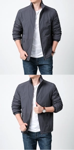 Detail of dark grey men's outdoor jacket with stand collar and windproof fabric texture