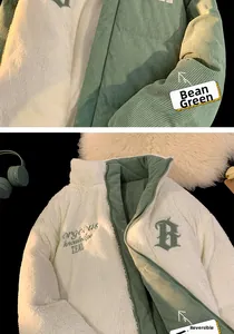 Detail of reversible jacket with green corduroy and white fleece showing embroidered logo