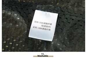 Detail view of the 100% polyester fabric mesh texture and washing label on the fishing vest