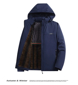 Detail of warm winter jacket featuring thick brown faux fur lining and windproof navy fabric