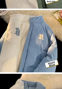 Detail of reversible dusty blue corduroy jacket with thick white sherpa lining and embroidery