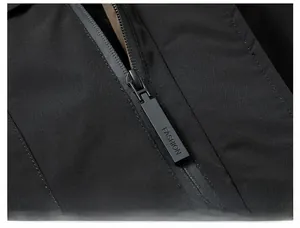 Detail shot of a black jacket with a premium metal zipper and windproof fabric texture