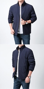 Detail view of navy blue men jacket with stand collar, zip pockets and elastic cuffs