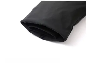Detail shot of the black windproof outer shell and ribbed elastic cuffs for winter warmth