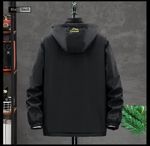 Detail view of the black outdoor jacket with adjustable hood and mountain logo print