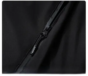 Macro detail of waterproof zipper on black winter jacket with FASHION letter branding
