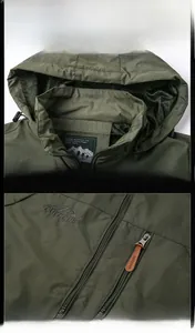 Detail view of hooded outdoor jacket with mesh lining and embroidered outdoor logo