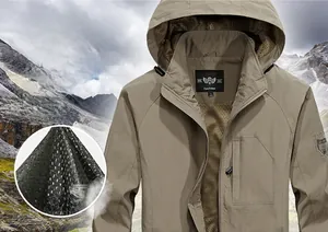 Detail view of the breathable mesh lining and zippered pocket on khaki windbreaker jacket