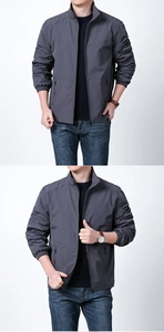 Detail view of men's dark grey windproof jacket featuring a stand collar and zip pockets