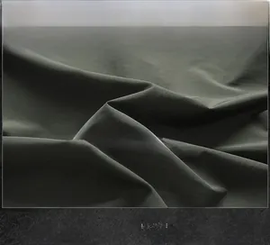 Close-up of windproof and breathable olive green fabric texture for outdoor jacket