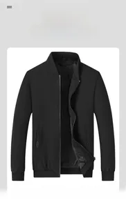 Detail view of black bomber jacket with ribbed cuffs, stand collar, and metal zipper