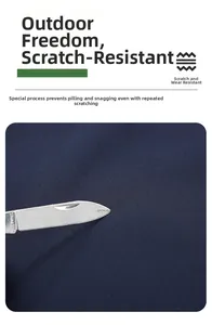 Detail of abrasion resistant dark blue fabric being tested with a knife for durability