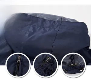 Detail of dark blue windproof hood showing the zipper and drawstring adjustment system