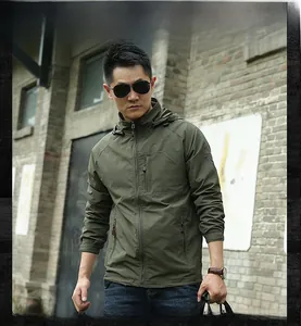 Detail of army green outdoor jacket featuring waterproof zipper pockets and hooded collar
