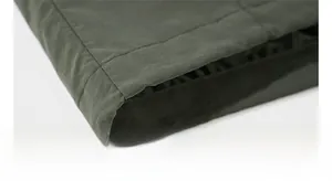 Macro view of double-stitched hem and waterproof fabric on men's outdoor jacket