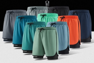 Close-up of dual-layer quick-dry sports shorts showing various colors and elastic waistband