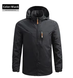 Close-up of black hooded outdoor jacket featuring chest zippers and mountain logo detail