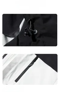 Detail of adjustable windproof hood toggles and waterproof zipper pocket on jacket