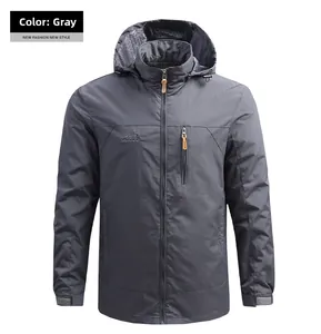 Detail view of grey outdoor hooded jacket featuring mesh lining and chest zipper pocket